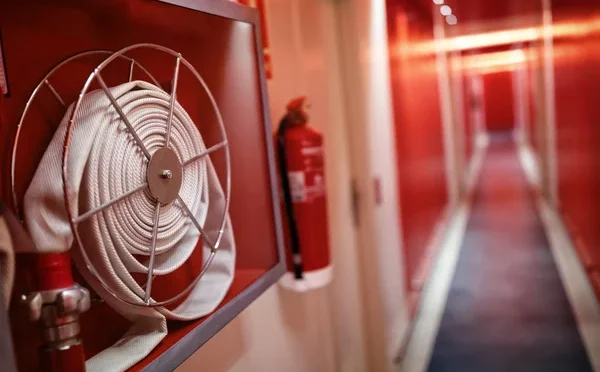 depositphotos_146949813-stock-photo-fire-extinguisher-and-hose-reel