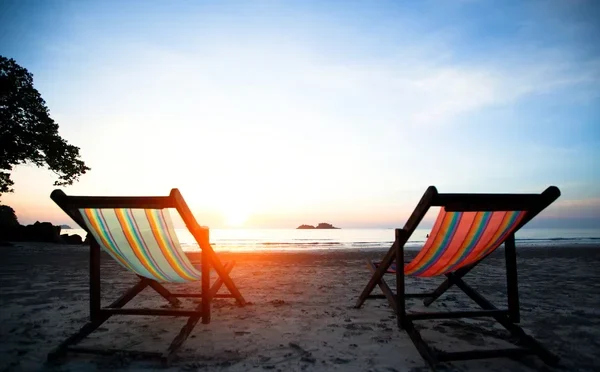 depositphotos_19843245-stock-photo-couple-of-beach-chairs-on