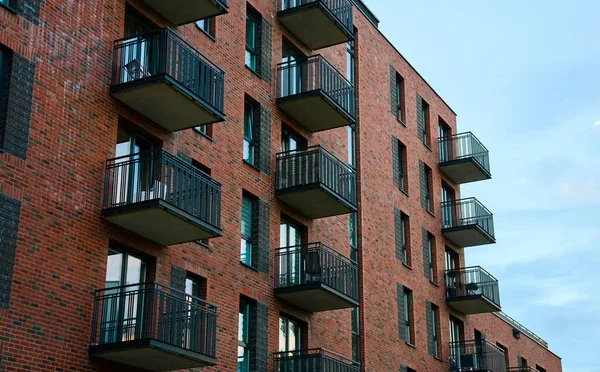 depositphotos_689813218-stock-photo-residential-building-facade-balconies-windows